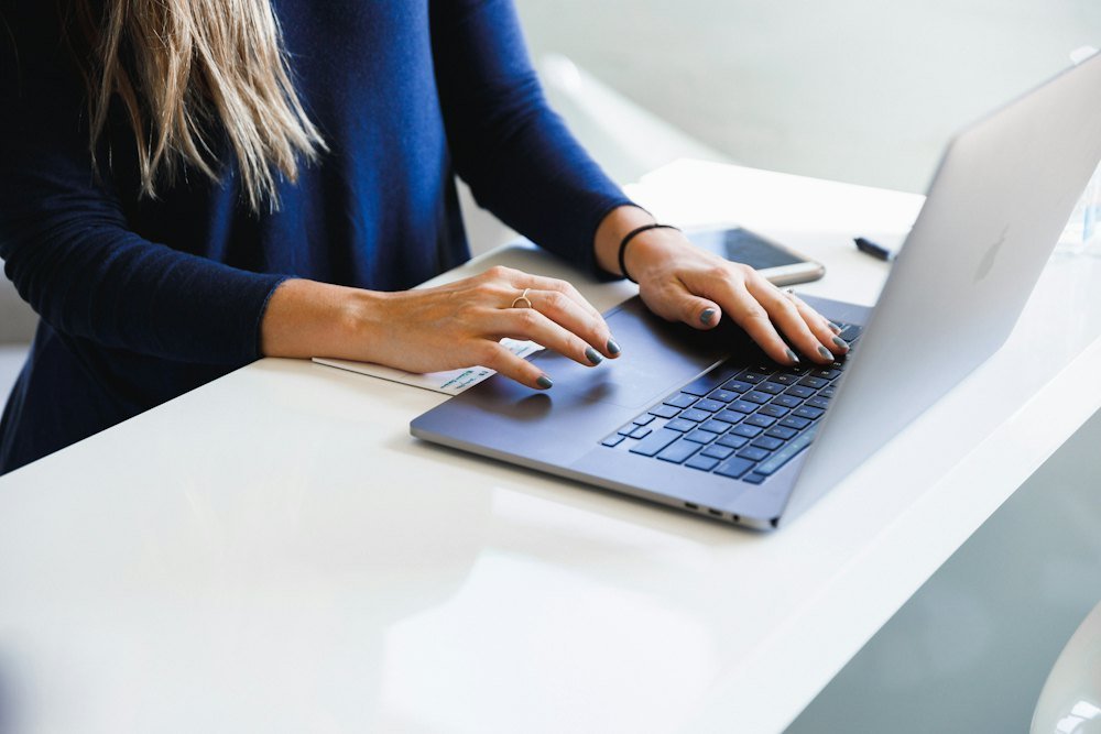 A professional working on a laptop at her desk