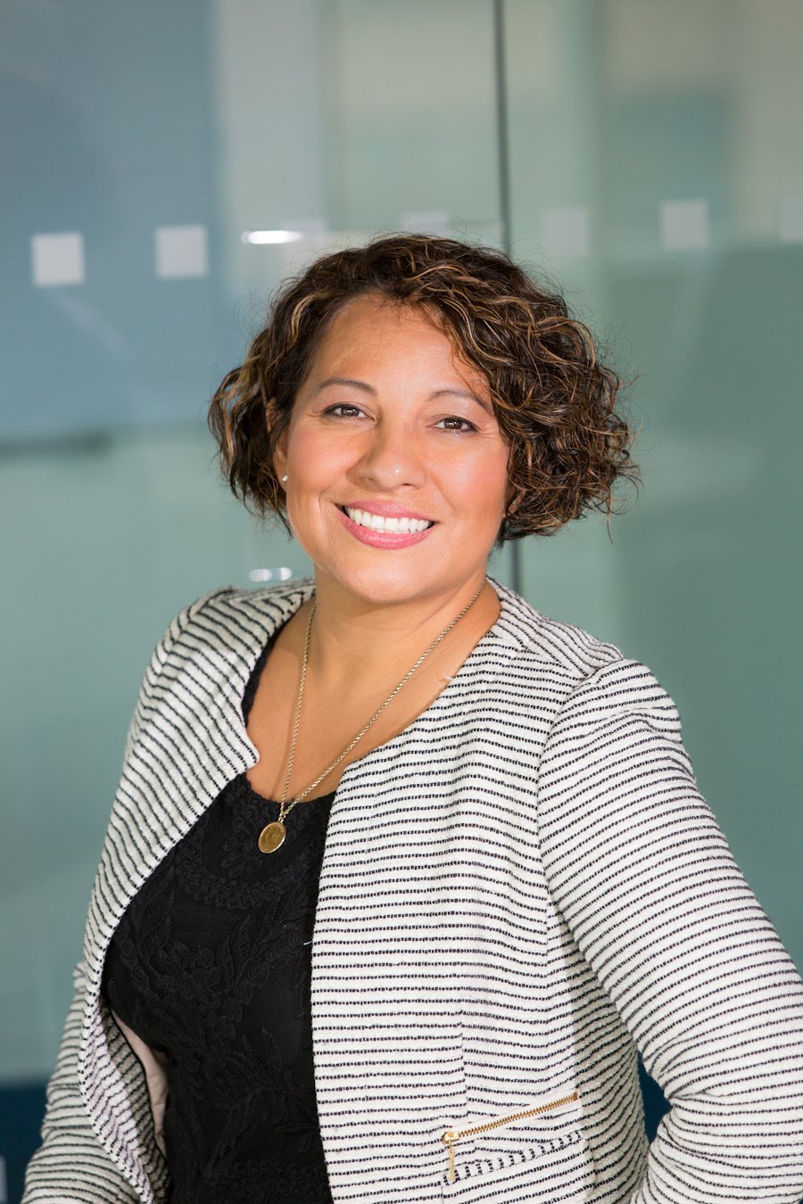 A facilities professional smiling in a modern office